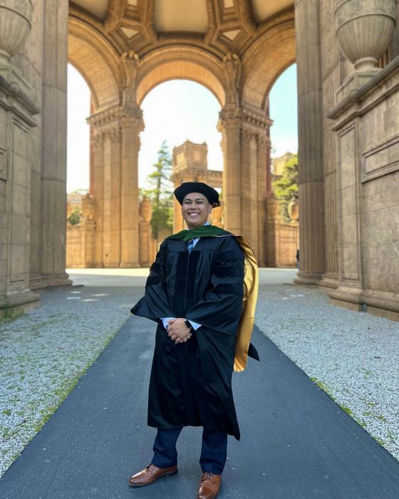 Matt in doctoral graduation regalia under a stone rotunda