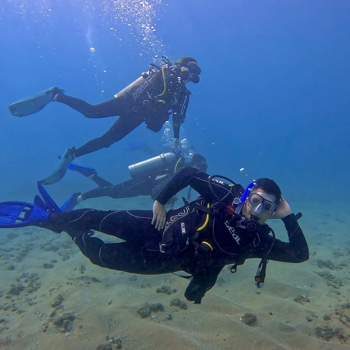 Matt scuba diving over a sandy sea floor